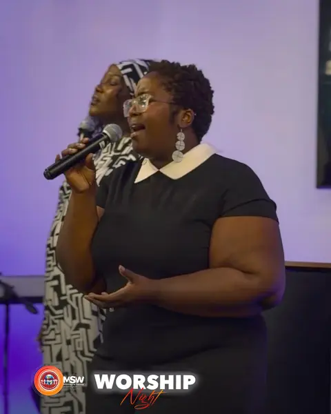 Two singers of the worship team leading a song