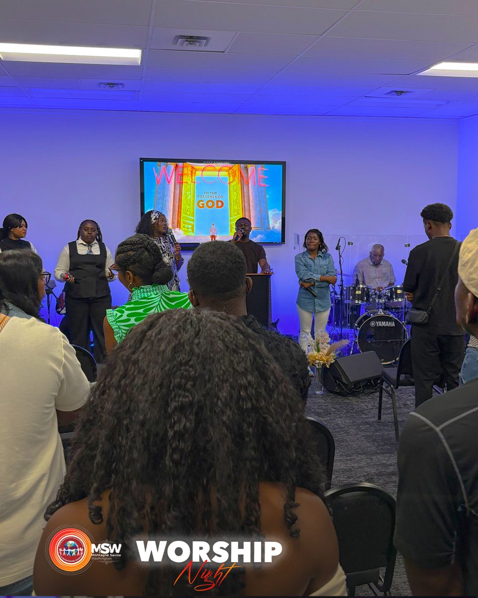 The congregation of Holy Mountain Washington Church standing in worship during a Sunday gathering